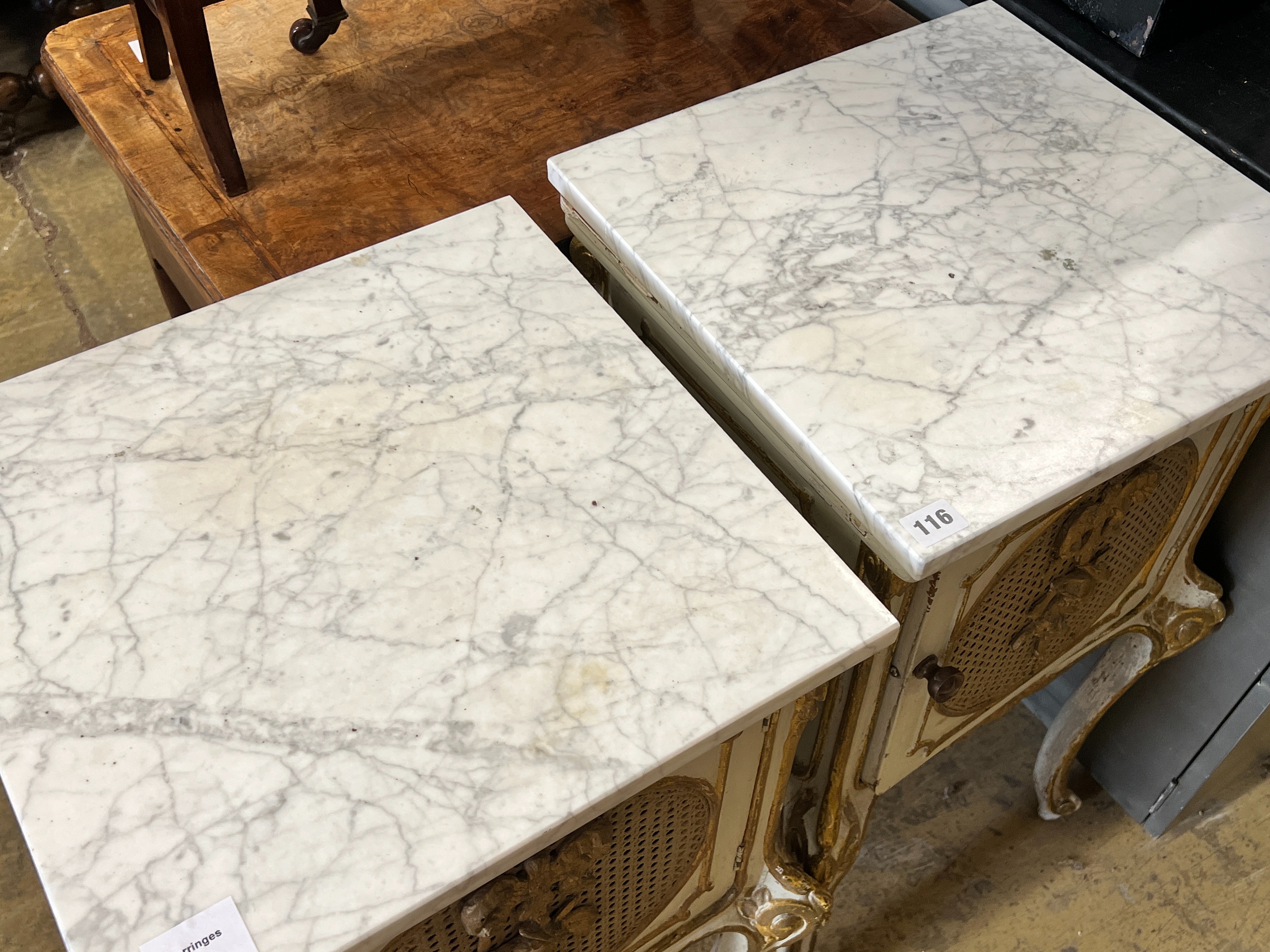 A pair of French caned parcel gilt marbled topped bedside cabinets, width 44cm, depth 41cm, height 78cm